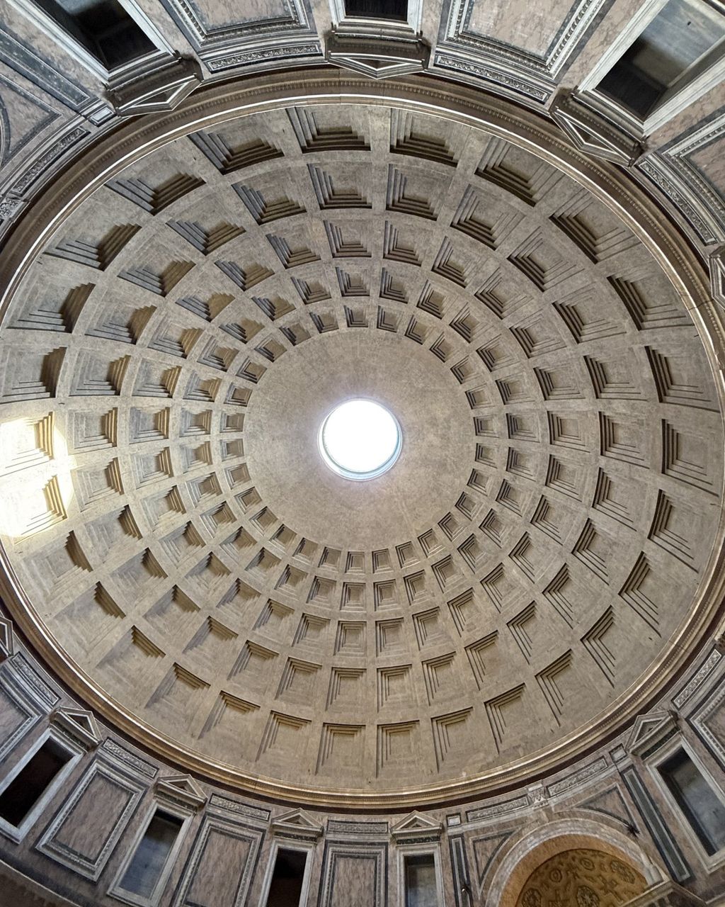 Looking straight up inside the Pantheon: the coffered concrete dome and the open oculus
