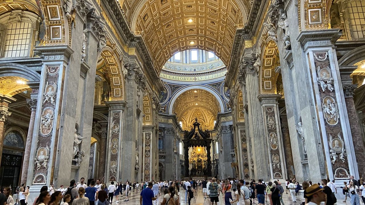 Nave of St. Peter's Basilica, gilded vault and the baldachin at the far end