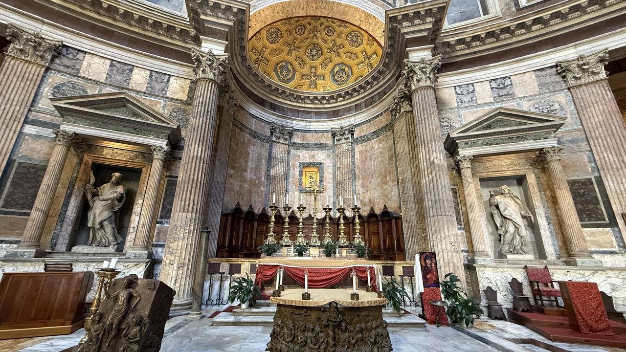The high altar and golden apse of the Pantheon, framed by the rotunda's marble columns and niches
