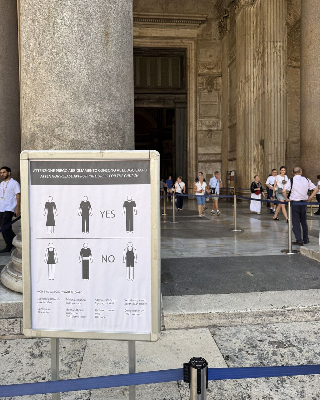 The dress code sign at the Pantheon entrance: pictogram figures marked yes and no, listing sleeveless tops, short skirts and see-through clothes as not allowed