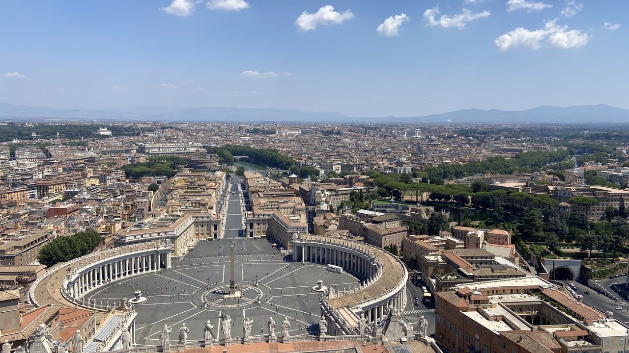 The view from the top of St. Peter's dome over the square, the colonnade and Via della Conciliazione running into Rome