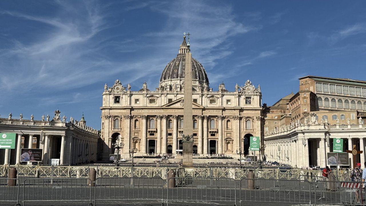 St. Peter's Basilica and the obelisk from the square on a clear September morning, barriers and a handful of visitors