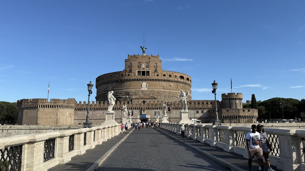 Castel Sant'Angelo and the Ponte Sant'Angelo statues from the bridge on a clear morning