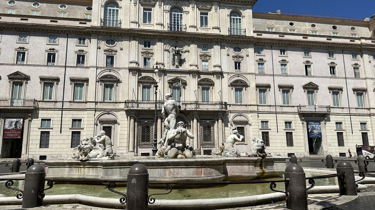 Piazza Navona in the morning, the Moor fountain and cafe awnings before the crowds arrive